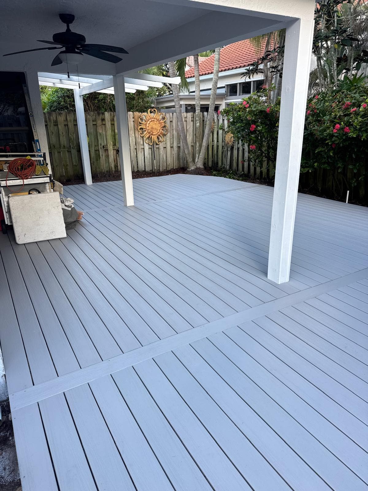 Large gray composite Trex deck with white pergola and ceiling fan Palm Beach County