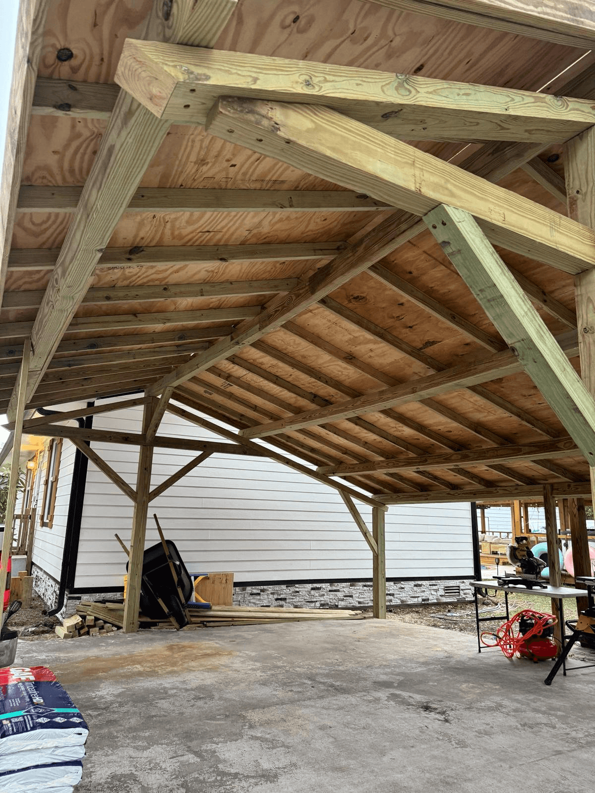 Exposed timber roof frame rafters looking up from inside large outdoor pavilion by Benito Fine Carpentry