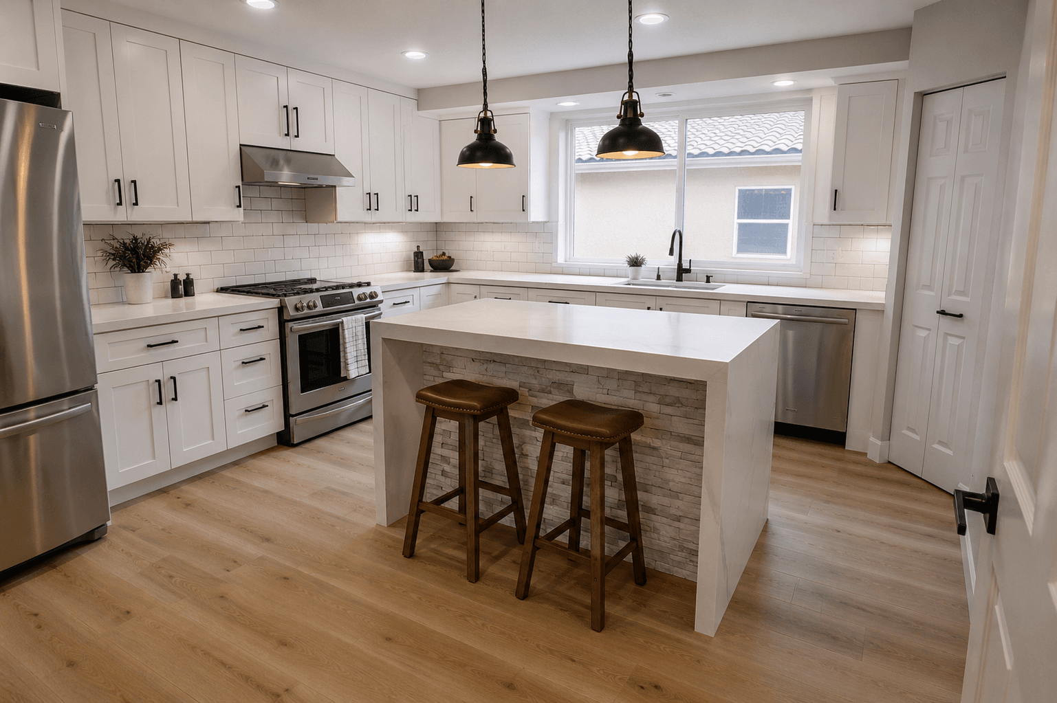 White shaker cabinet kitchen remodel with quartz waterfall island and stone veneer base by Benito Fine Carpentry Wellington FL