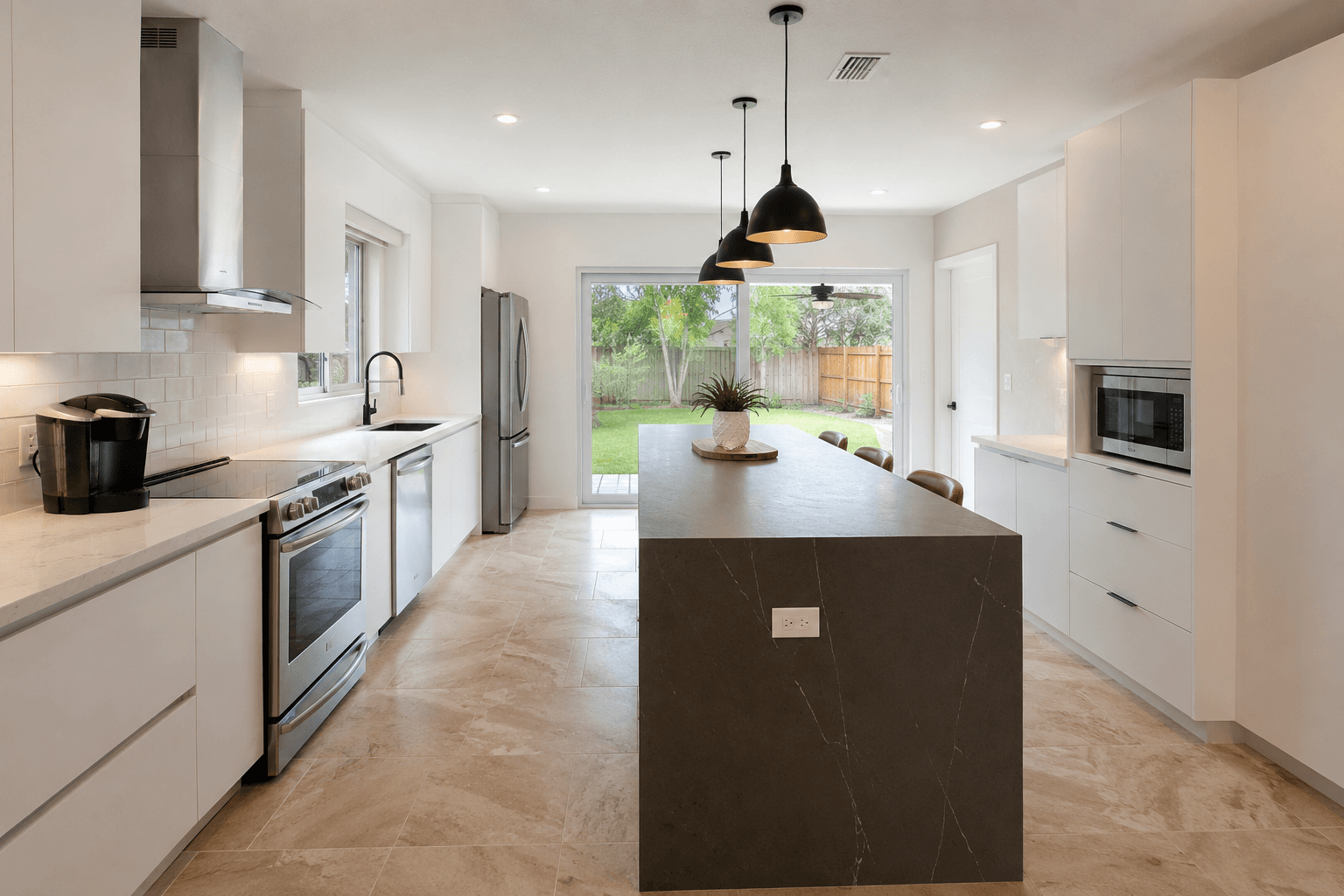 Modern kitchen remodel charcoal waterfall island white cabinets herringbone floor by Benito Fine Carpentry South Florida