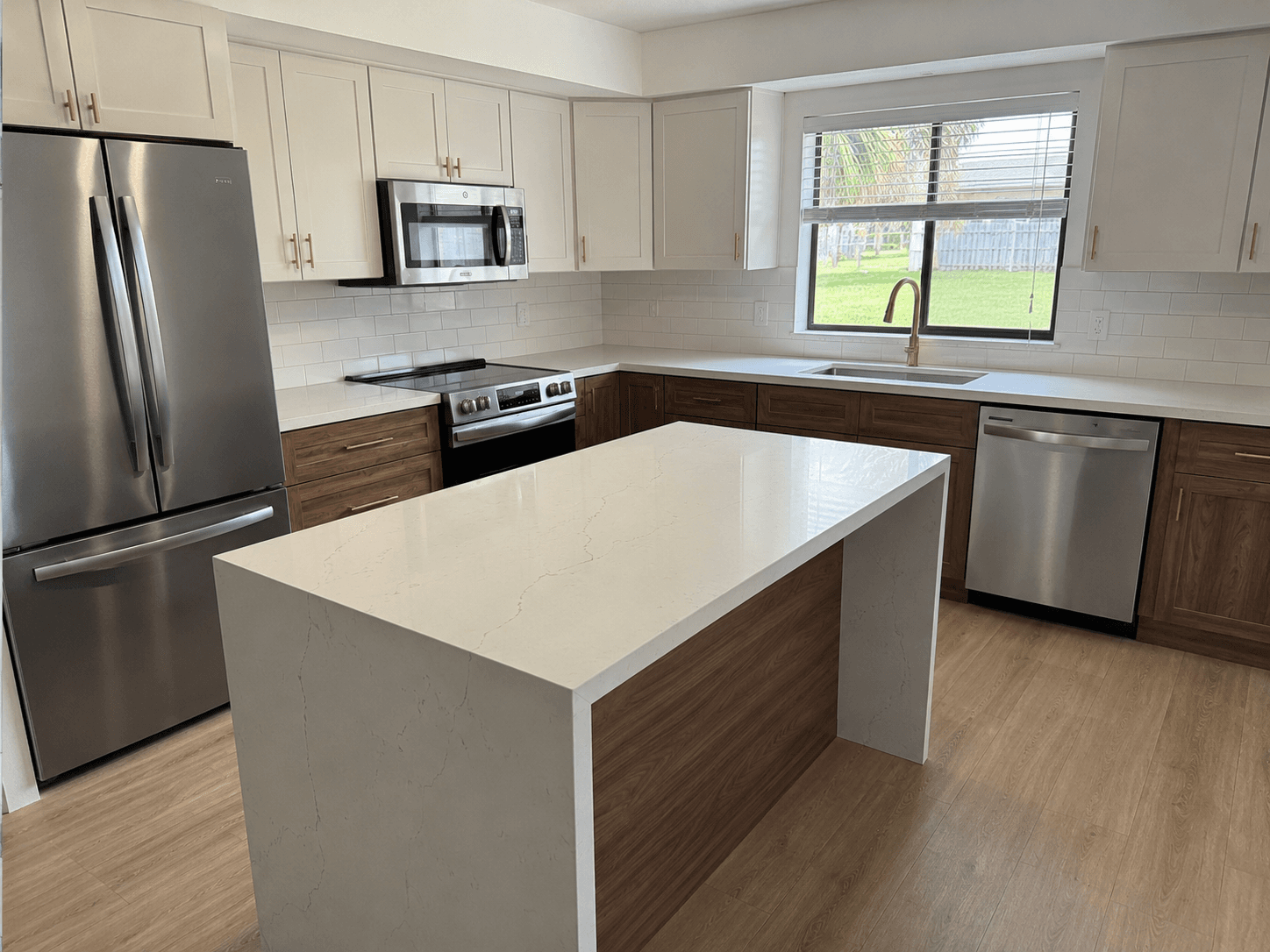Custom walnut lower cabinets white upper cabinets quartz island kitchen remodel by Benito Fine Carpentry Wellington FL