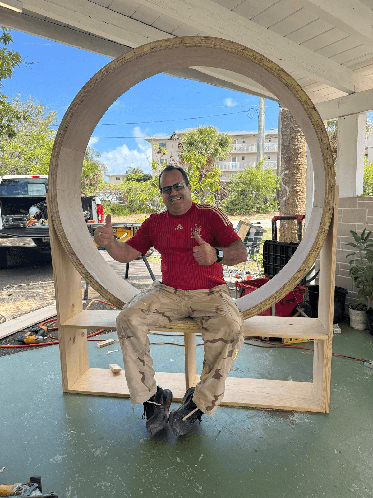 Benito Gonzalez — master carpenter with 30 years of experience — inside a custom circular wood structure he built, Wellington FL