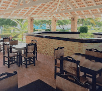 Covered outdoor bar with seating area and tropical garden view built by Benito Fine Carpentry South Florida