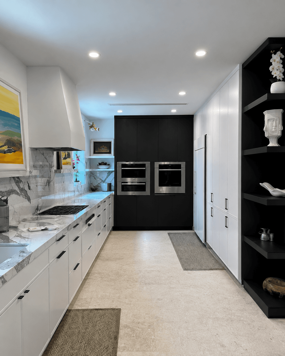 High-end kitchen remodel with gray high-gloss cabinetry white marble countertops and travertine floors by Benito Fine Carpentry Palm Beach County