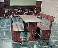 Handcrafted wood dining table with matching benches on tiled patio — hotel-grade millwork by Benito Fine Carpentry