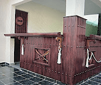 Rustic handcrafted wooden bar counter with rope accent detailing side view by Benito Fine Carpentry South Florida